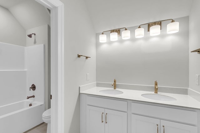 bathroom with shower / tub combination, a sink, toilet, and double vanity