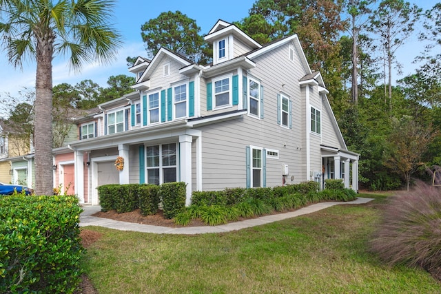 view of front of home with a front yard and a garage