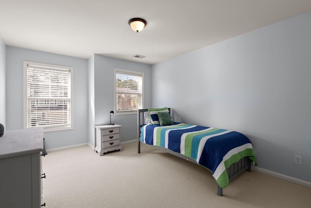 bedroom featuring light carpet