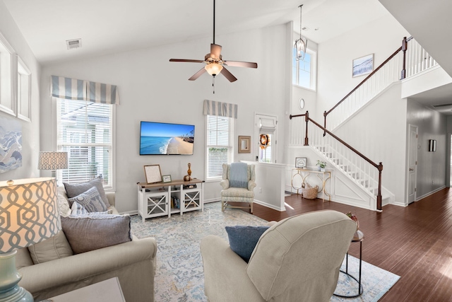 living room featuring ceiling fan, high vaulted ceiling, and dark hardwood / wood-style floors