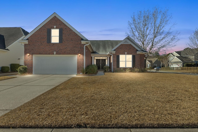 view of front facade featuring a garage, concrete driveway, and brick siding