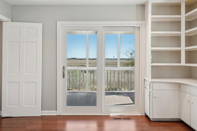 entryway with dark wood-type flooring and visible vents