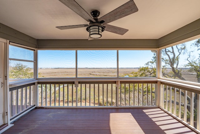 unfurnished sunroom with a ceiling fan