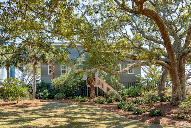 exterior space featuring stairway and a front lawn