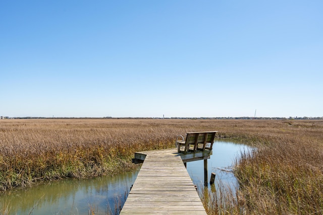 view of dock featuring a water view and a rural view