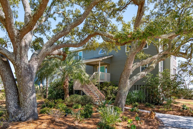 view of front of home featuring stairs and a porch