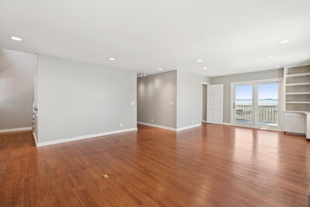 unfurnished room featuring recessed lighting, baseboards, and wood finished floors