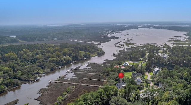 drone / aerial view featuring a water view and a forest view