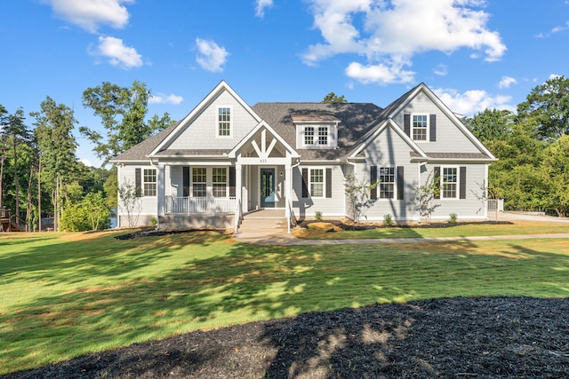 craftsman-style house with covered porch and a front lawn