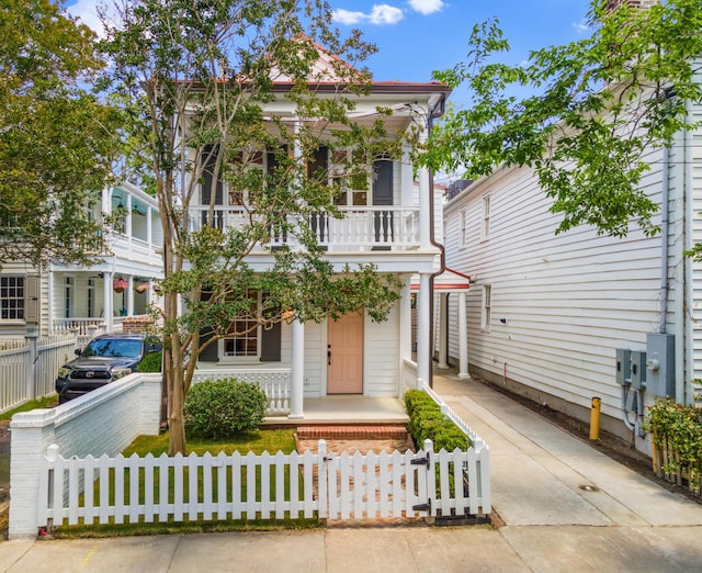 80 Smith St, Charleston, SC 29401 - view of front of house featuring a porch, a balcony, and a fenced front yard