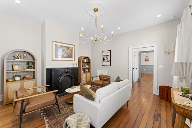 80 Smith St, Charleston, SC 29401 - living room with a chandelier, built in shelves, wood-type flooring, recessed lighting, and baseboards