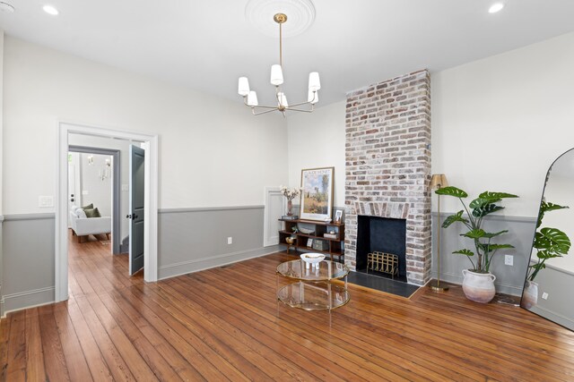 80 Smith St, Charleston, SC 29401 - living room with hardwood / wood-style floors, baseboards, a chandelier, a fireplace, and recessed lighting