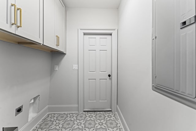 80 Smith St, Charleston, SC 29401 - laundry area with hookup for an electric dryer, cabinet space, baseboards, and light tile patterned floors