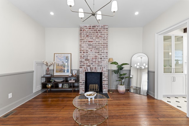 80 Smith St, Charleston, SC 29401 - living area featuring a chandelier, a brick fireplace, wood-type flooring, recessed lighting, and baseboards