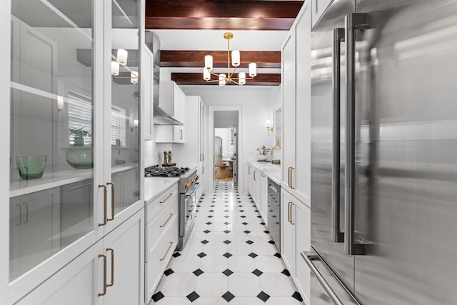 80 Smith St, Charleston, SC 29401 - kitchen featuring premium appliances, a chandelier, beam ceiling, white cabinetry, and a sink