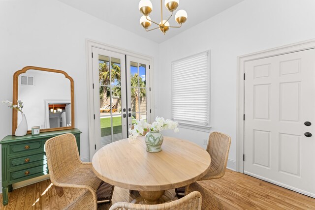 80 Smith St, Charleston, SC 29401 - dining area with a chandelier, french doors, and wood finished floors