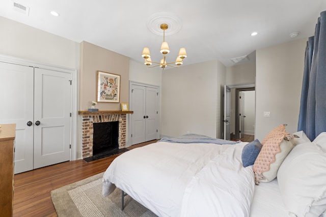 80 Smith St, Charleston, SC 29401 - bedroom featuring wood finished floors, a chandelier, a fireplace, and recessed lighting