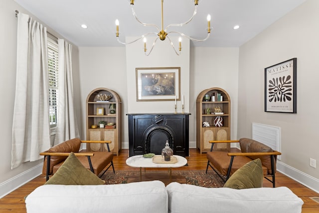 80 Smith St, Charleston, SC 29401 - living area featuring wood finished floors, a chandelier, baseboards, a fireplace, and recessed lighting