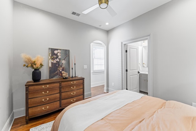 80 Smith St, Charleston, SC 29401 - bedroom featuring baseboards, wood finished floors, connected bathroom, a ceiling fan, and recessed lighting