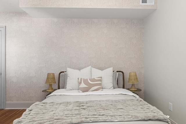 80 Smith St, Charleston, SC 29401 - bedroom with baseboards, dark wood-style floors, and wallpapered walls