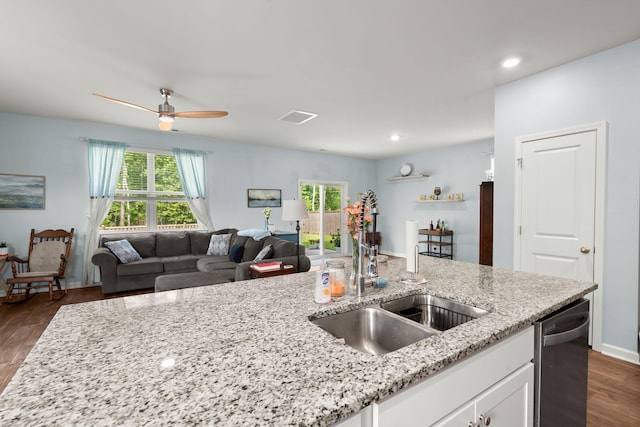 kitchen featuring visible vents, a sink, dark wood-type flooring, white cabinets, and stainless steel dishwasher