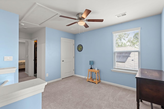 interior space with visible vents, a ceiling fan, and baseboards