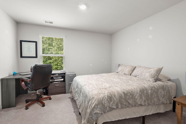 bedroom with visible vents and carpet flooring