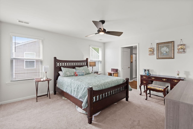 bedroom with light carpet, visible vents, a ceiling fan, and baseboards