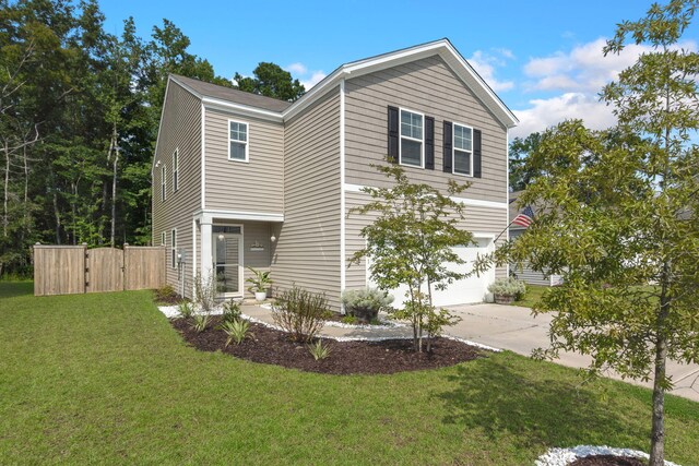 view of front of property with a garage and a front yard