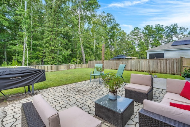 view of patio with area for grilling, a fenced backyard, and an outdoor hangout area