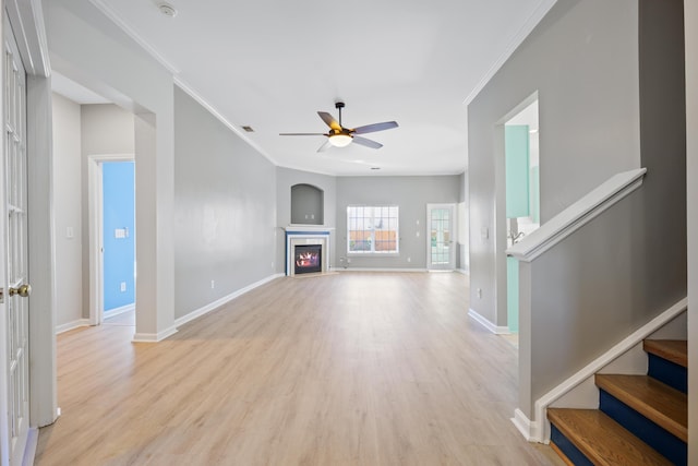 unfurnished living room featuring ceiling fan, light hardwood / wood-style flooring, and ornamental molding