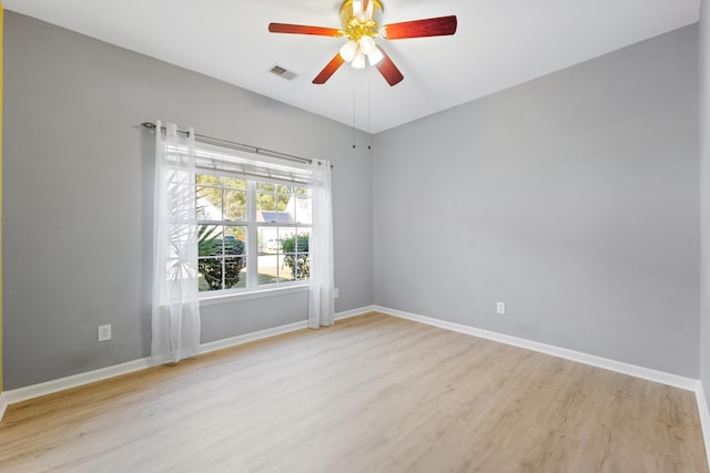 spare room featuring light wood-type flooring and ceiling fan