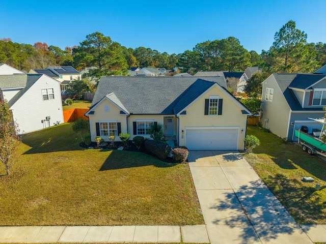 view of front of house with a garage and a front lawn