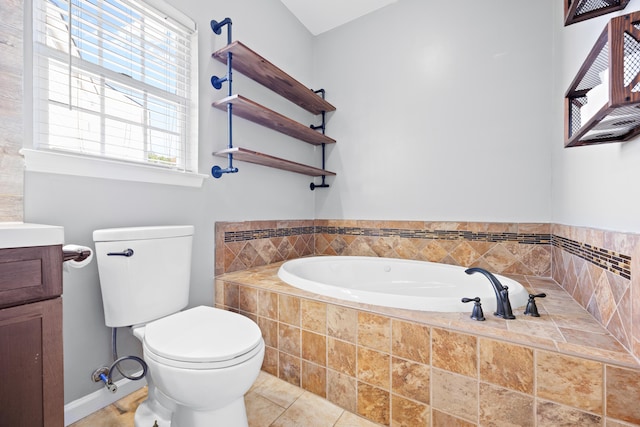 bathroom with vanity, toilet, a wealth of natural light, and tiled bath