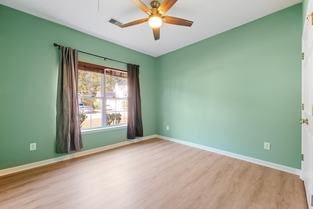 spare room with ceiling fan and light wood-type flooring