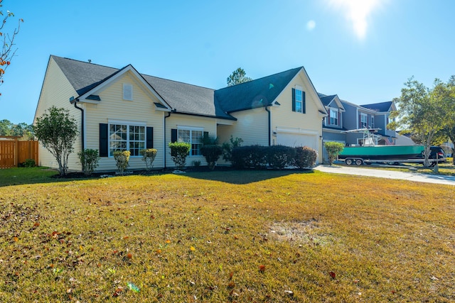 view of front of property with a garage and a front yard