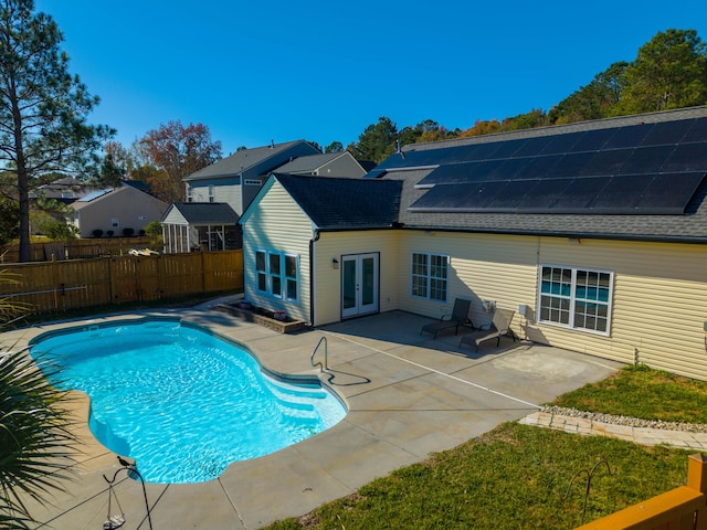 view of swimming pool with a patio and french doors