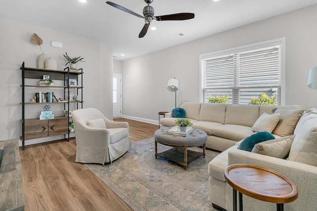 living room featuring hardwood / wood-style flooring and ceiling fan