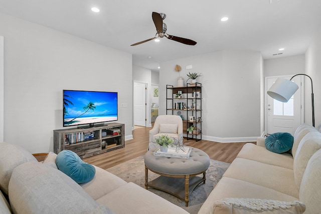 living room with ceiling fan and light hardwood / wood-style floors