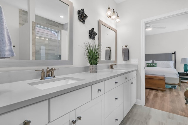 bathroom with ceiling fan, hardwood / wood-style floors, vanity, and an enclosed shower