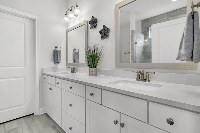 bathroom featuring hardwood / wood-style floors, vanity, and walk in shower