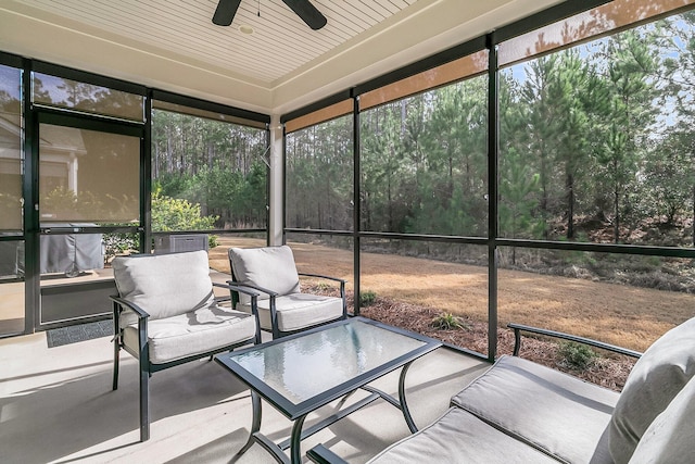 sunroom with ceiling fan and wood ceiling