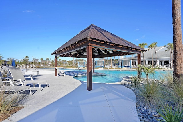 view of swimming pool with a gazebo and a patio area