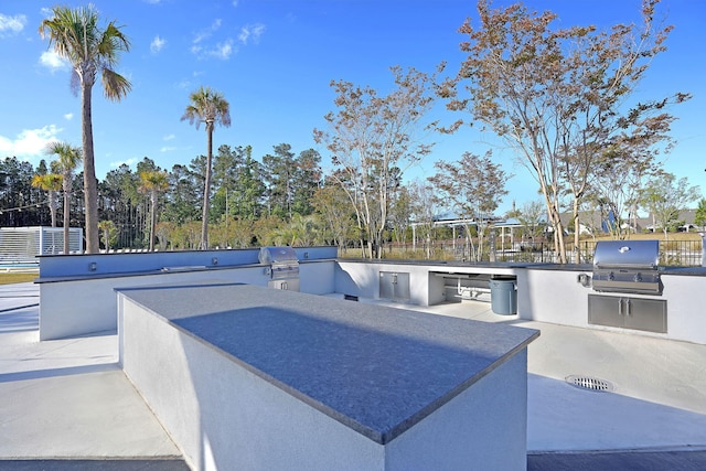 view of patio featuring exterior kitchen and grilling area