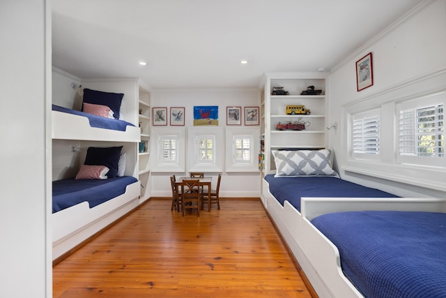 bedroom with crown molding and hardwood / wood-style flooring