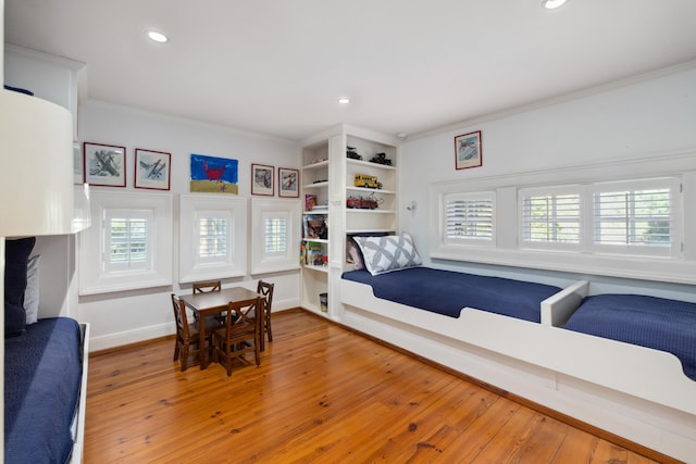 bedroom featuring crown molding and hardwood / wood-style flooring