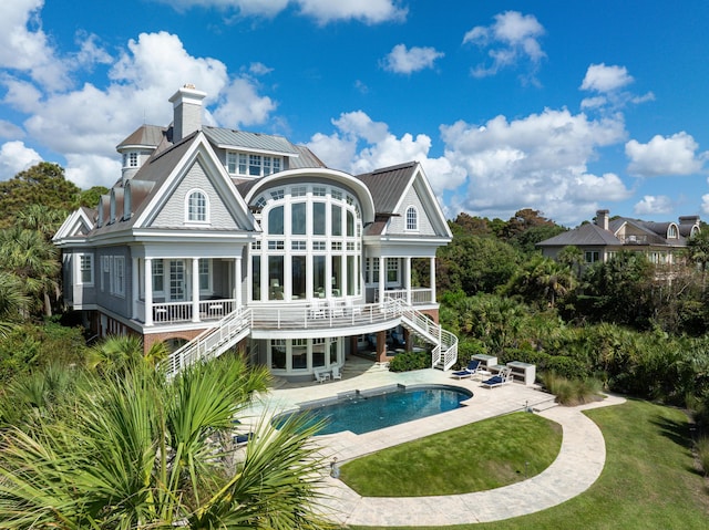 back of house featuring a patio and a sunroom