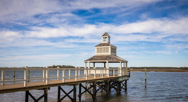 view of dock with a gazebo and a water view