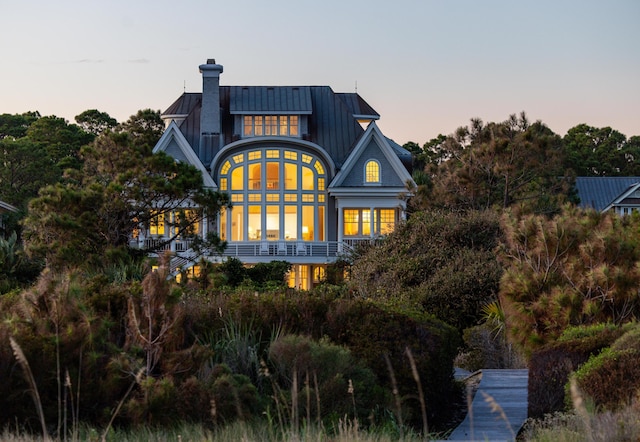 view of back house at dusk