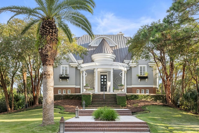 victorian home with french doors and a front lawn